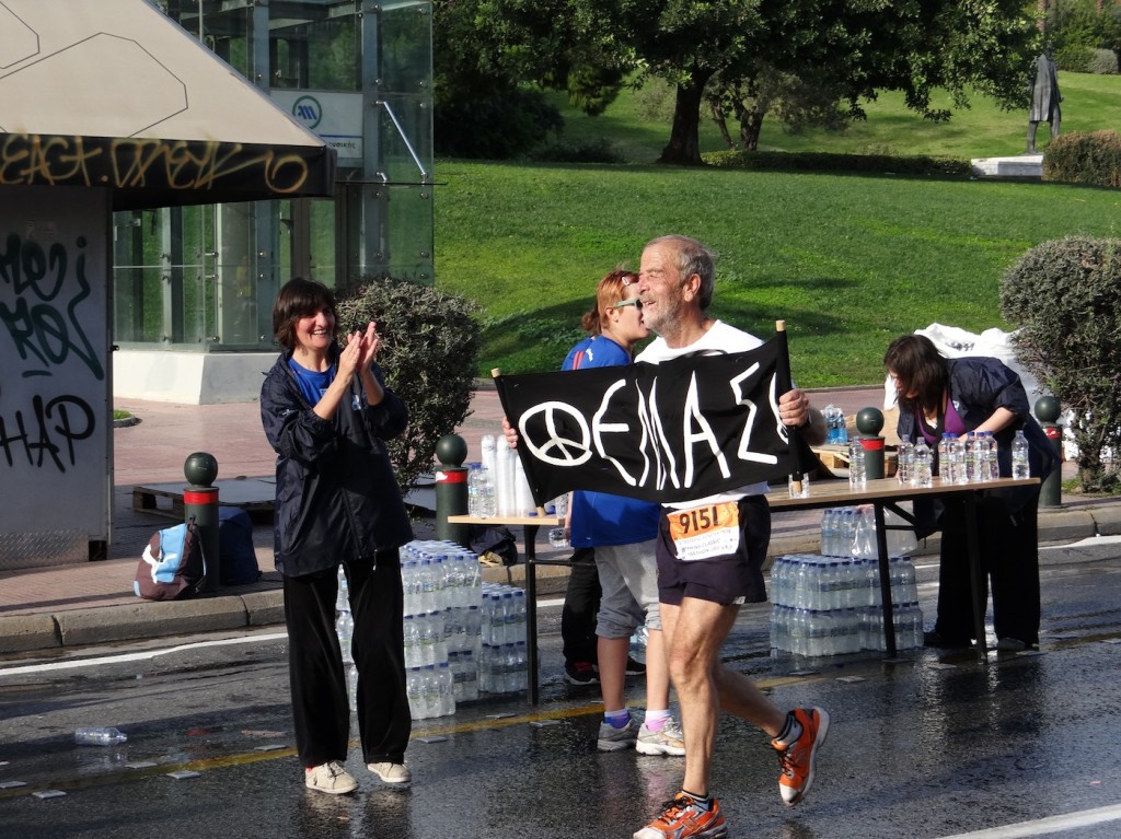 An older runner with an "ΕΛΛΑΣ" (Greece) sign. This represents the sense of Greek pride that was so strong that day 