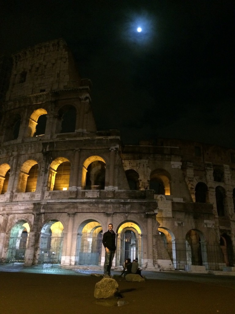 Beautiful moon with the lit up Colosseum.