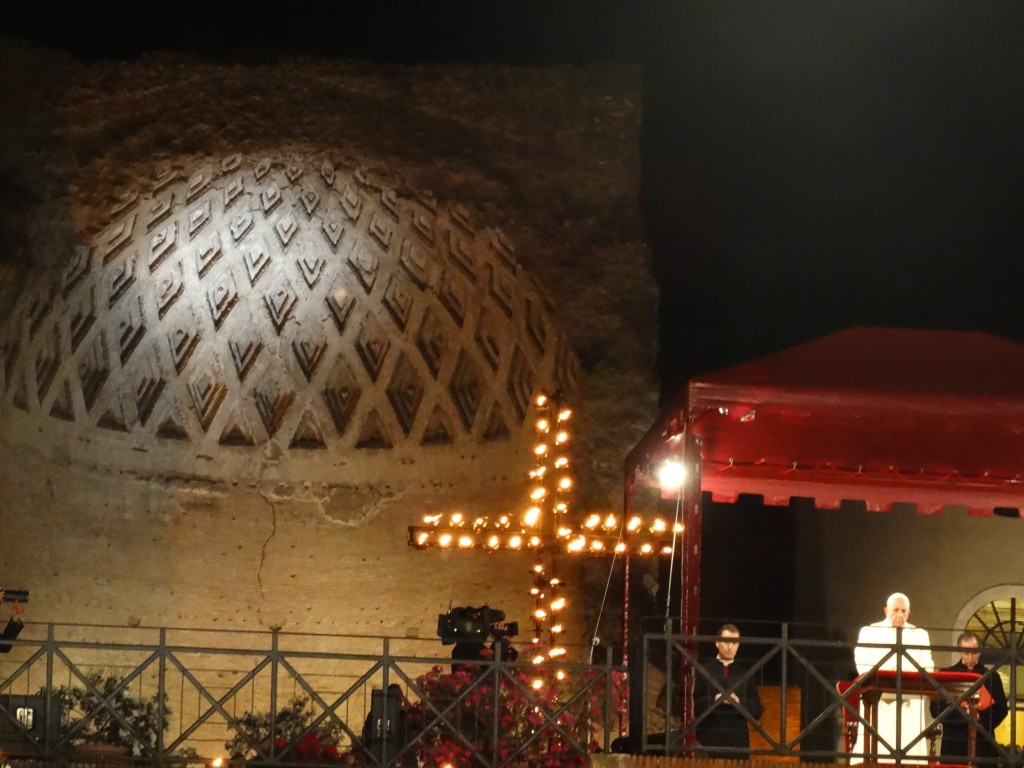 The gas light cross with the pope underneath the Basilica Nova, on the Palatine Hill for the Via Crucis.